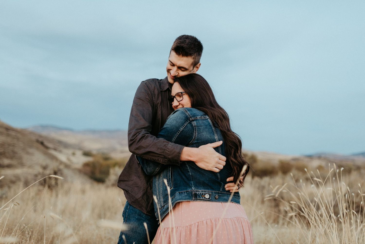 couple hugging on a hill overlooking downtown