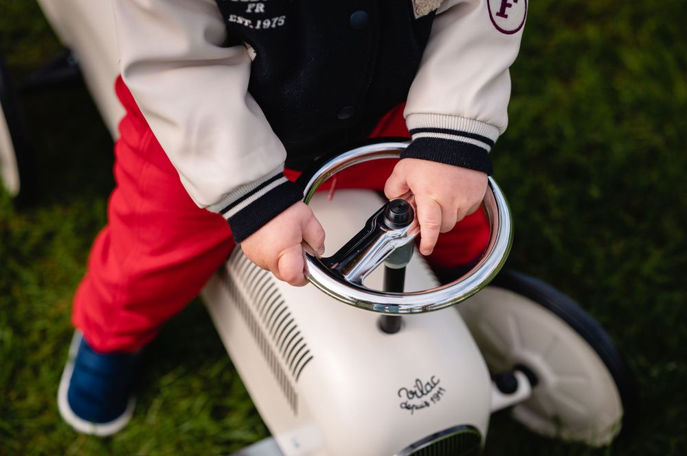 faceless image of boy on ride on vintage car