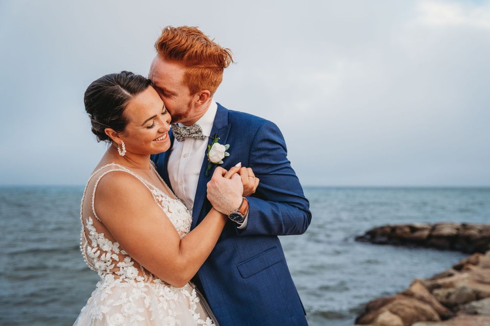 bride and groom kissing on the beach in cape cod Massachusetts