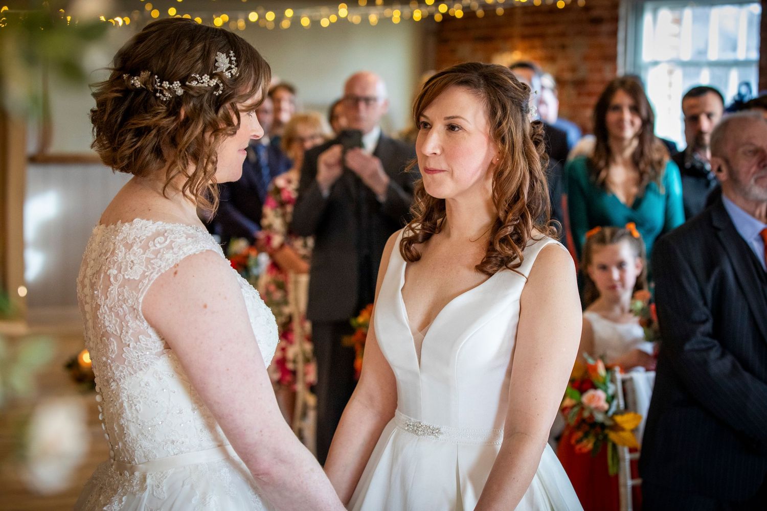 Wedding celebration in rustic venue with exposed brick walls and string lights.