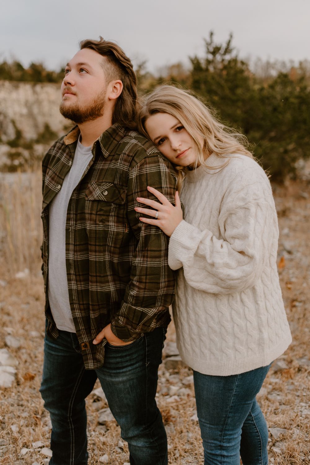 Candid moments between couple wearing cable knit sweater and plaid flannel.