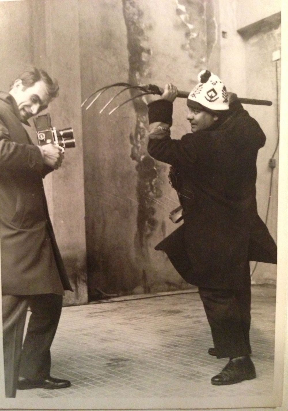 Historical black and white photograph showing a group engaged in photography practice.