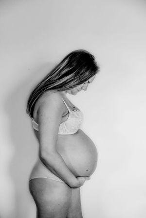 Black and white maternity silhouettes showing the progression of pregnancy.
