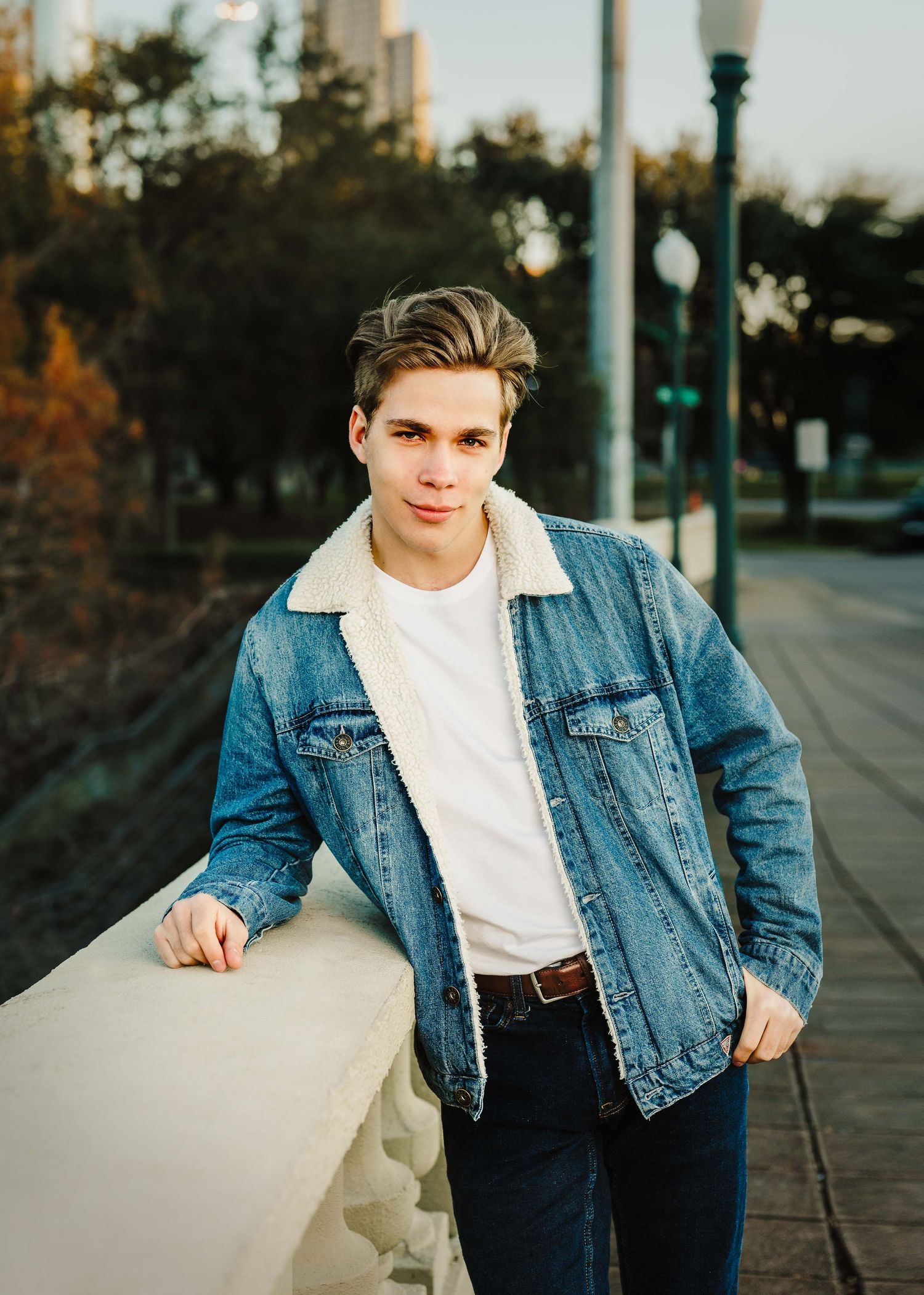 Urban fashion shoot featuring classic denim jacket and white t-shirt combination.