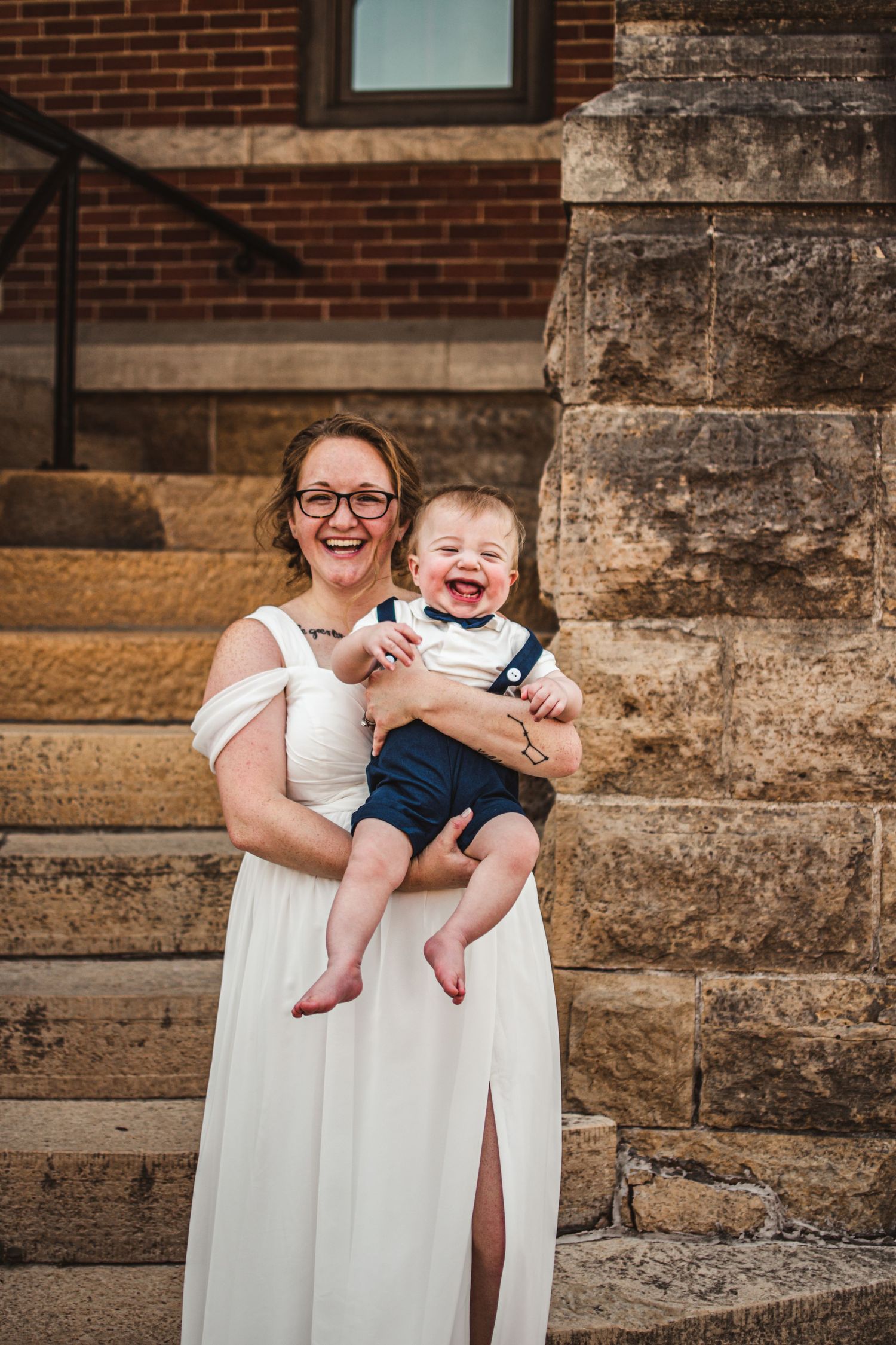 A joyful moment captured on stone steps with brick building backdrop.