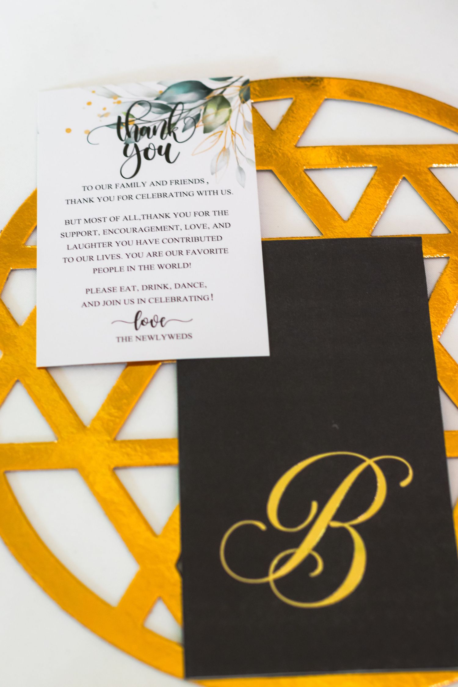 Wedding thank you note and monogrammed card with gold letter B on geometric background.