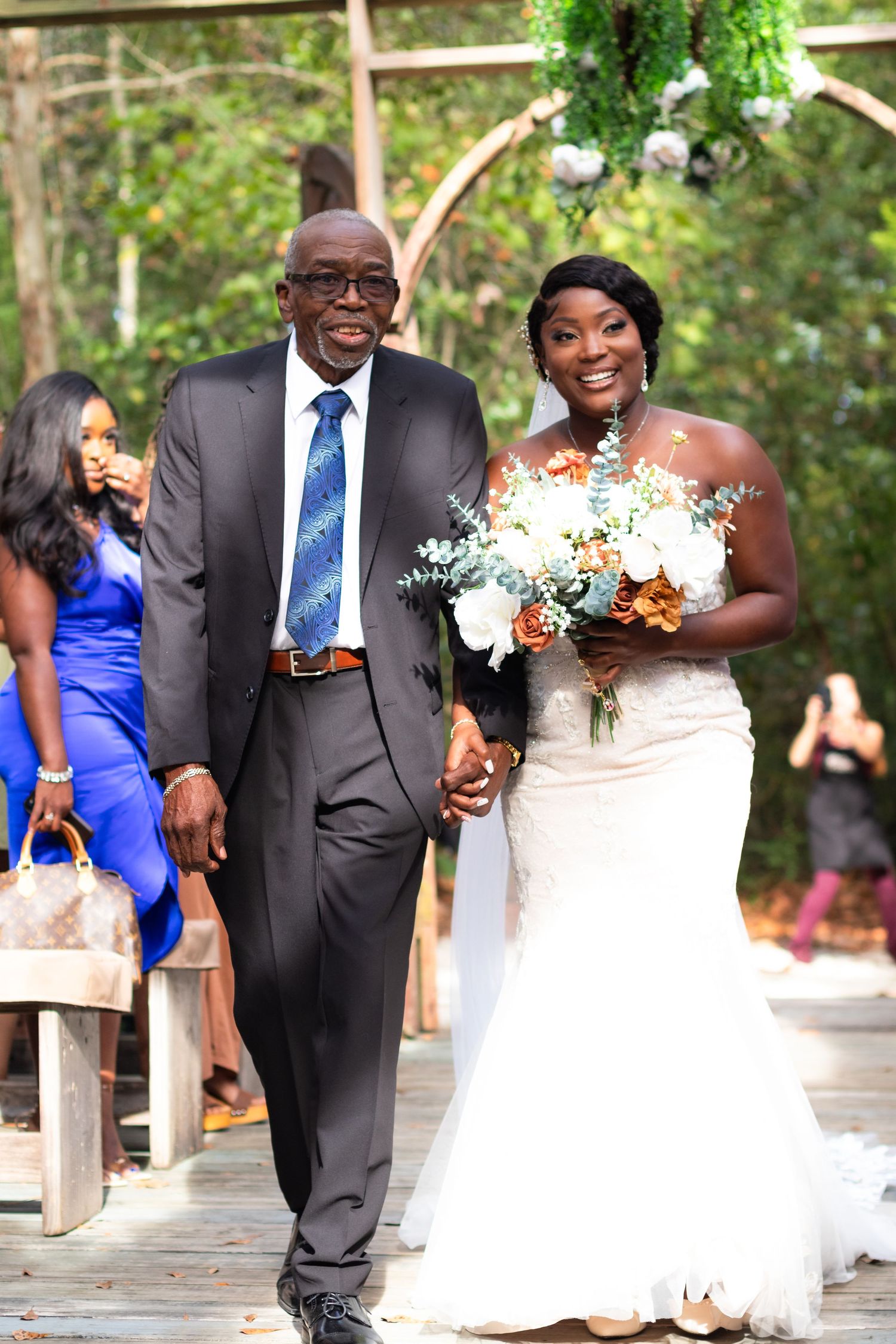Proud father walking his daughter down the aisle at the Bella Sera Gardens