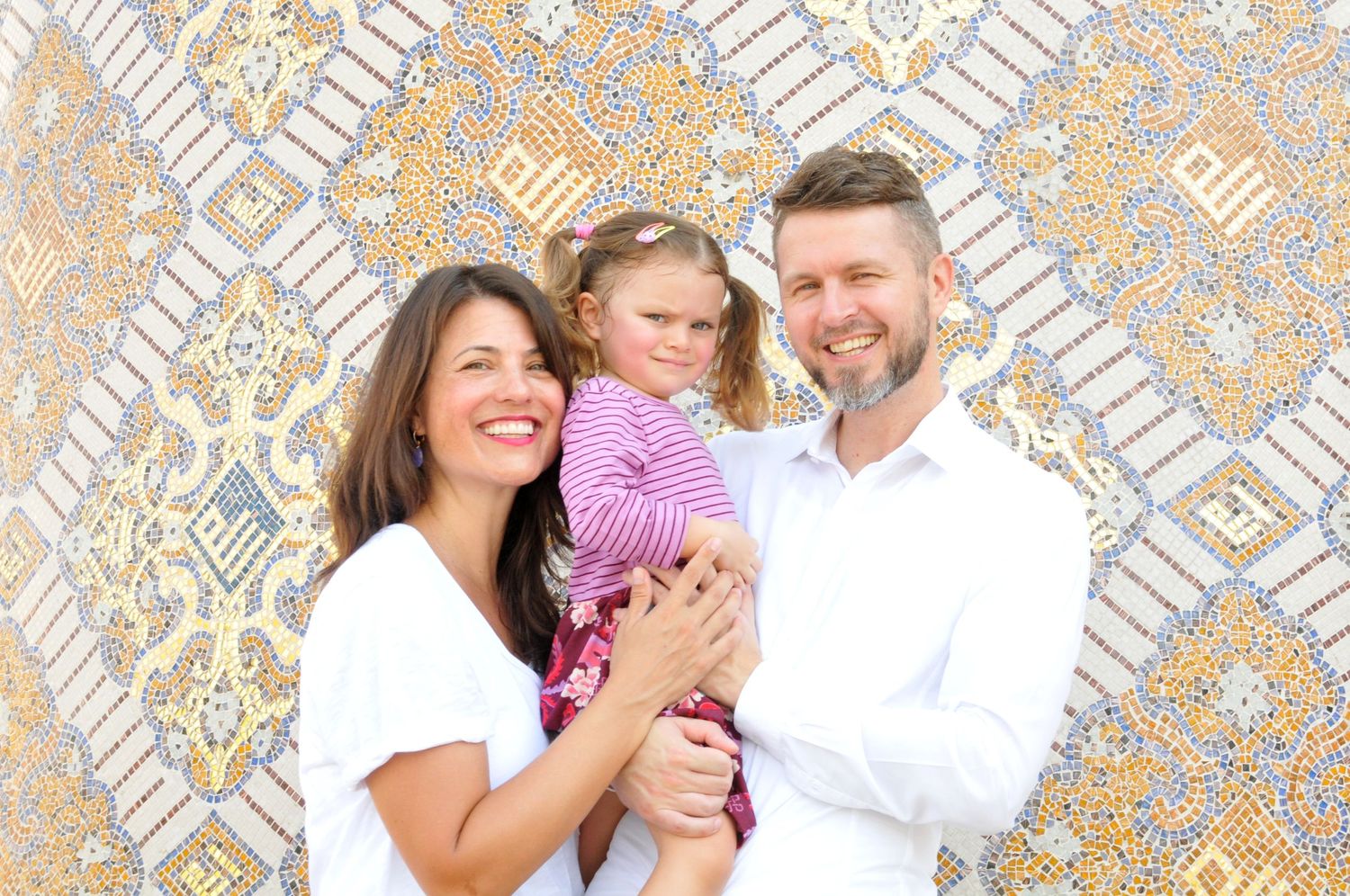 Photo of a family of three in Doha, Qatar with mosaic tile backdrop