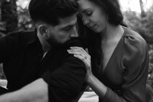 Black and white photo of couple sharing tender moment during outdoor portrait session.