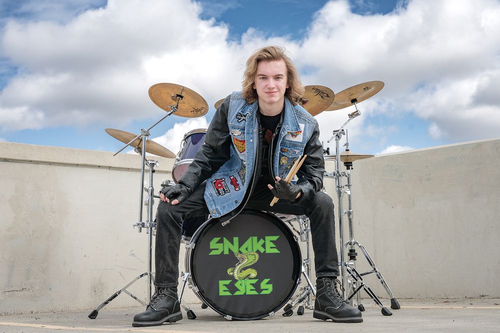 Kyle Taylor senior session parking structure rooftop with drum set