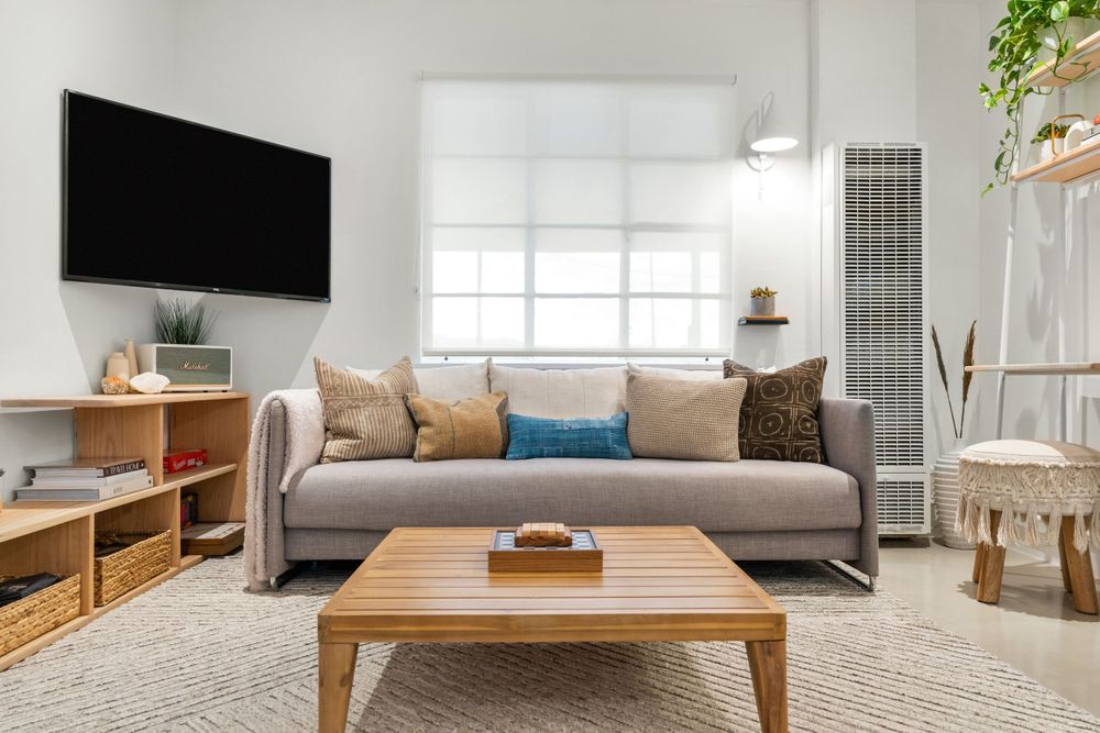 Bright living room with modern furnishings, natural light, and wood accents.