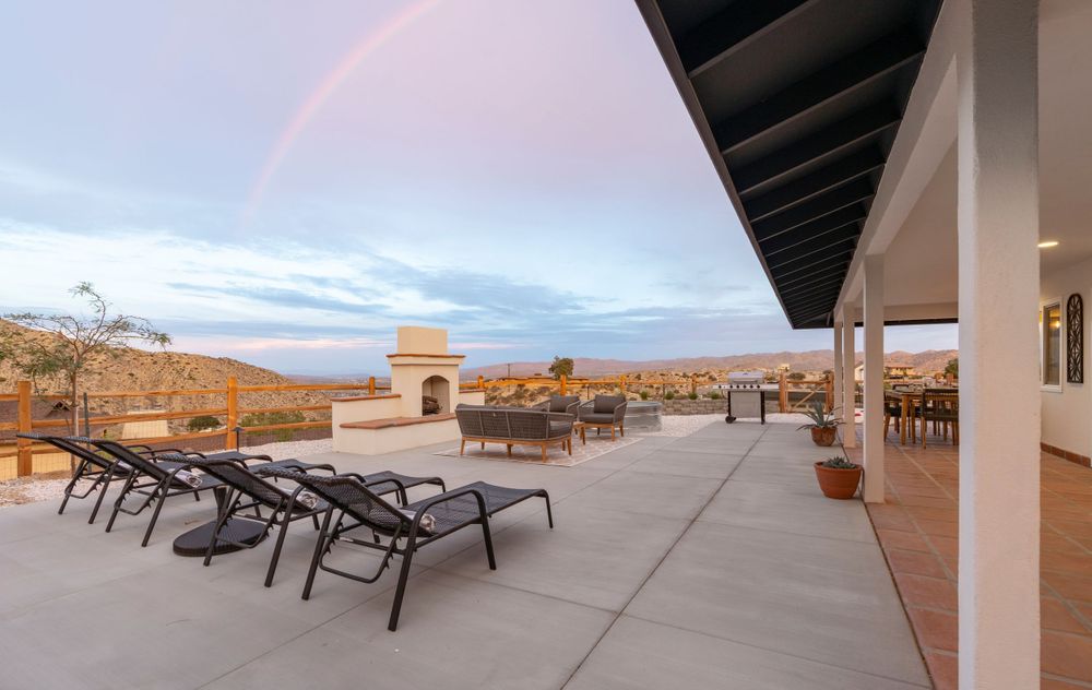 Spacious patio deck with lounge chairs and desert mountain views.
