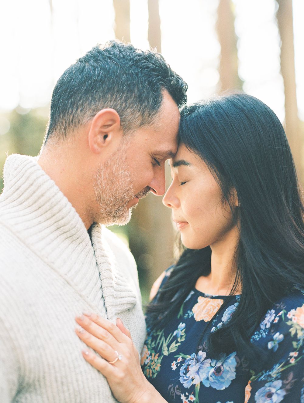 Intimate close-up of couple sharing tender moment in soft lighting.