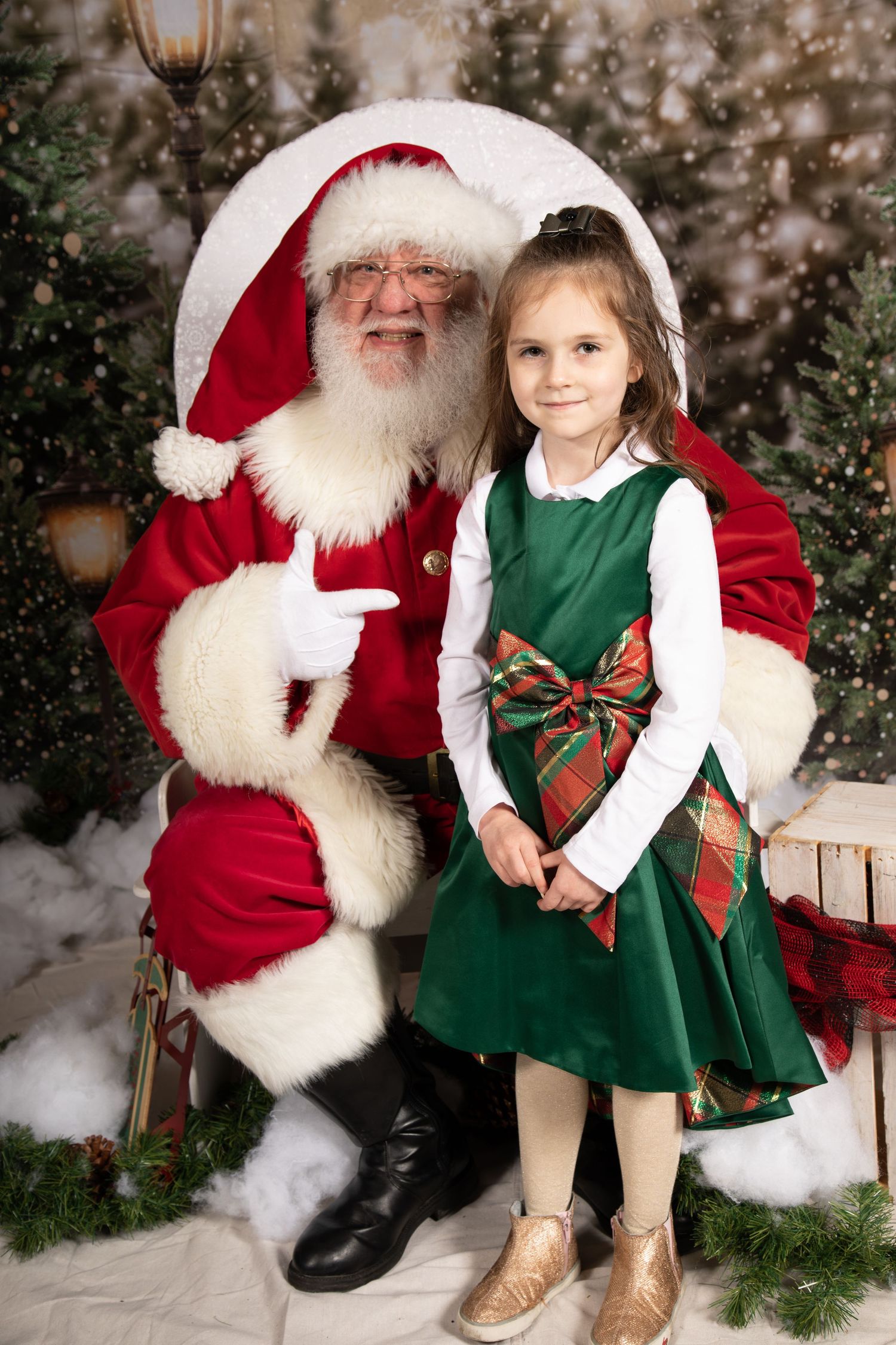 Festive Christmas portrait with decorated tree and glowing lantern in background.