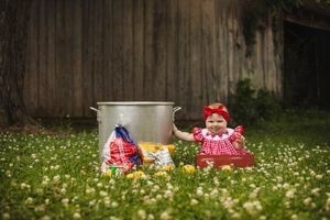 Collection of vintage-style dresses displayed in field of wildflowers.