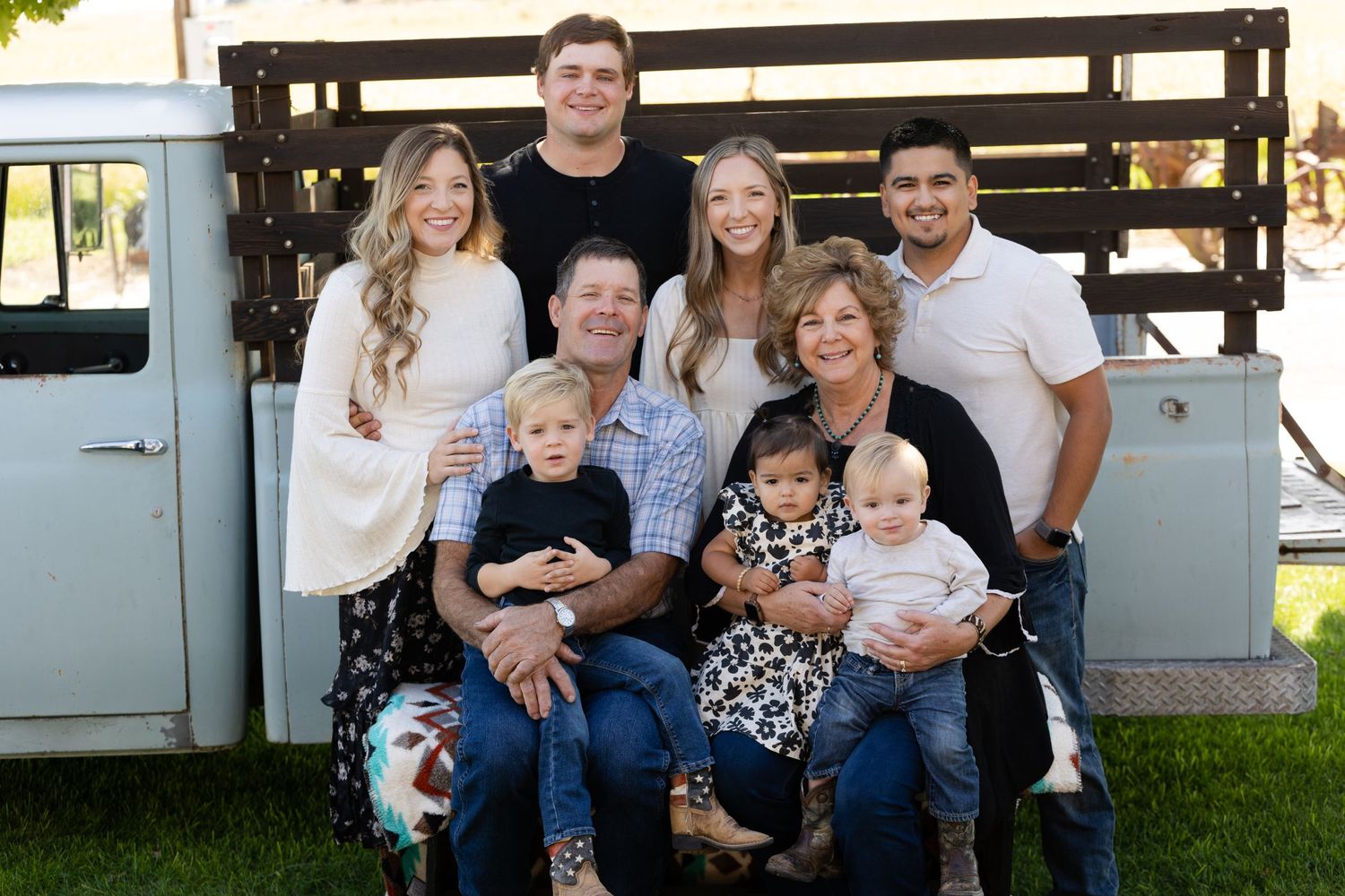 Family portrait session in Willows, California with old truck behind them