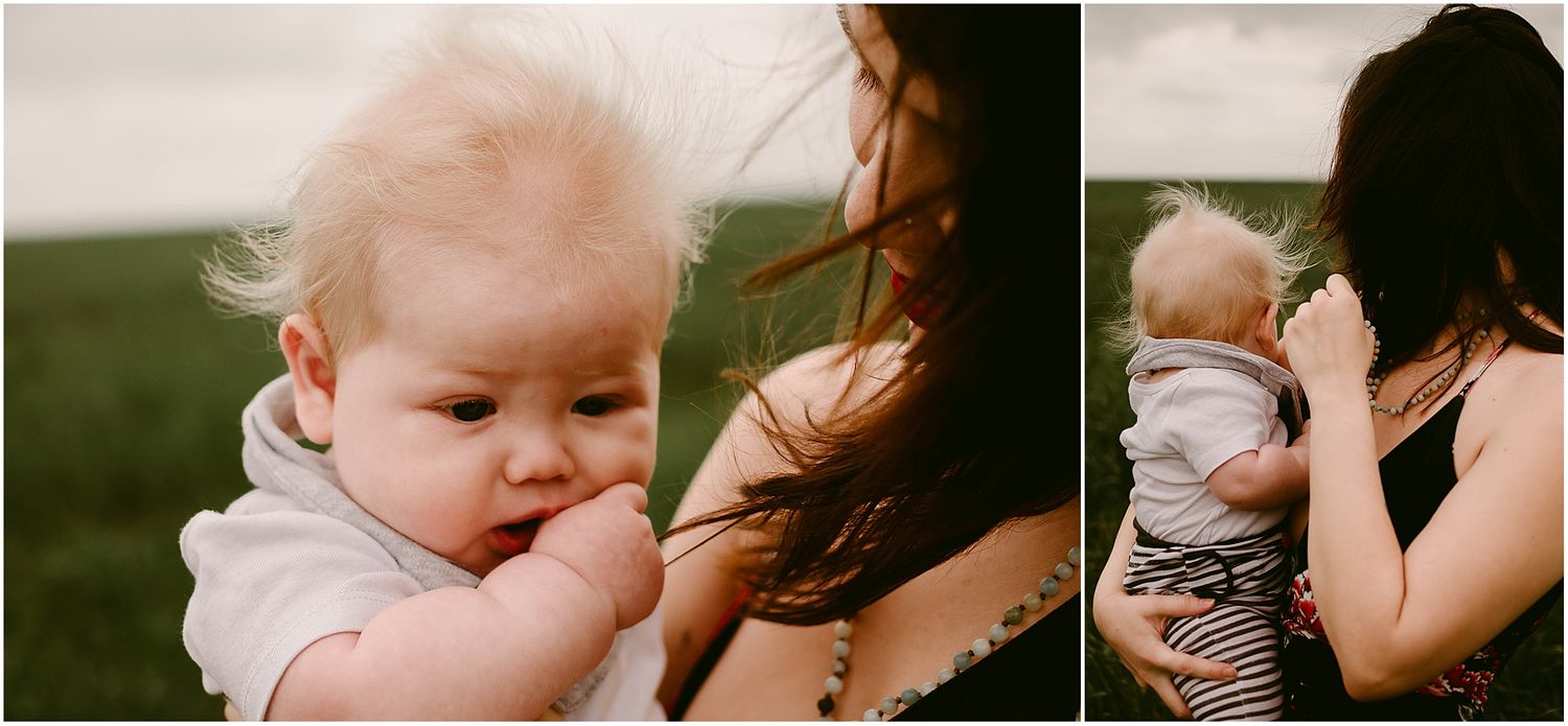 Intimate outdoor portrait showing baby touching while being held in a floral patterned dress.
