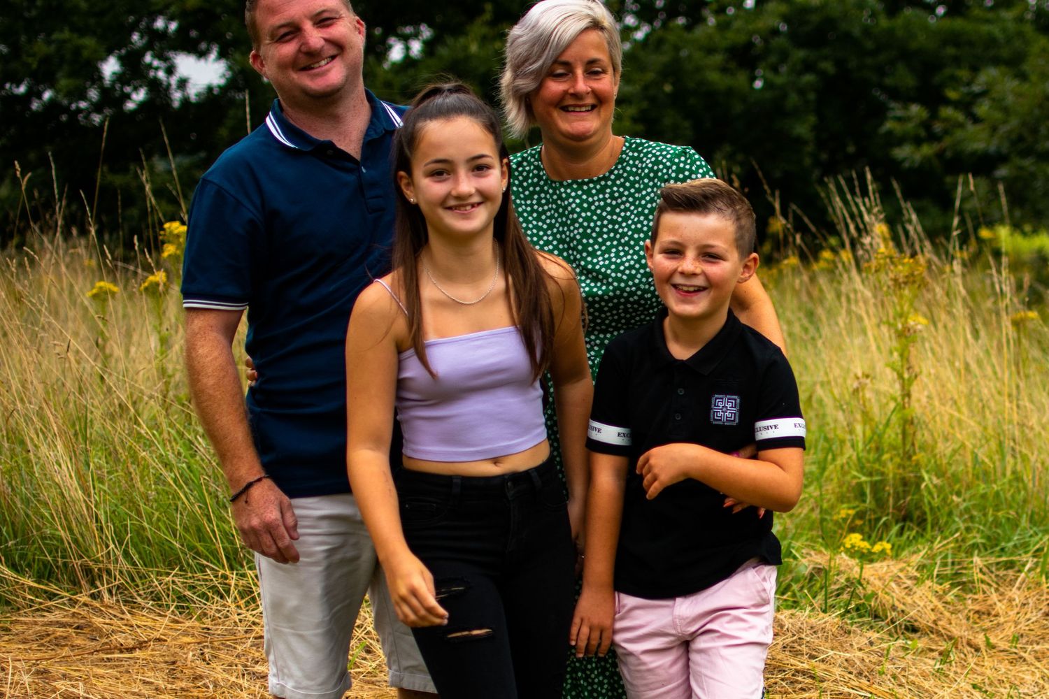 Teenage children laughing with their parents