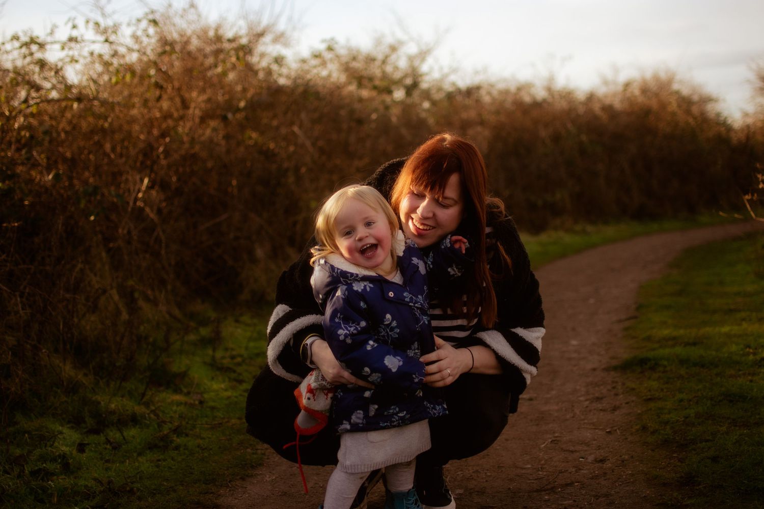 Mum and baby daughter paying in the woods