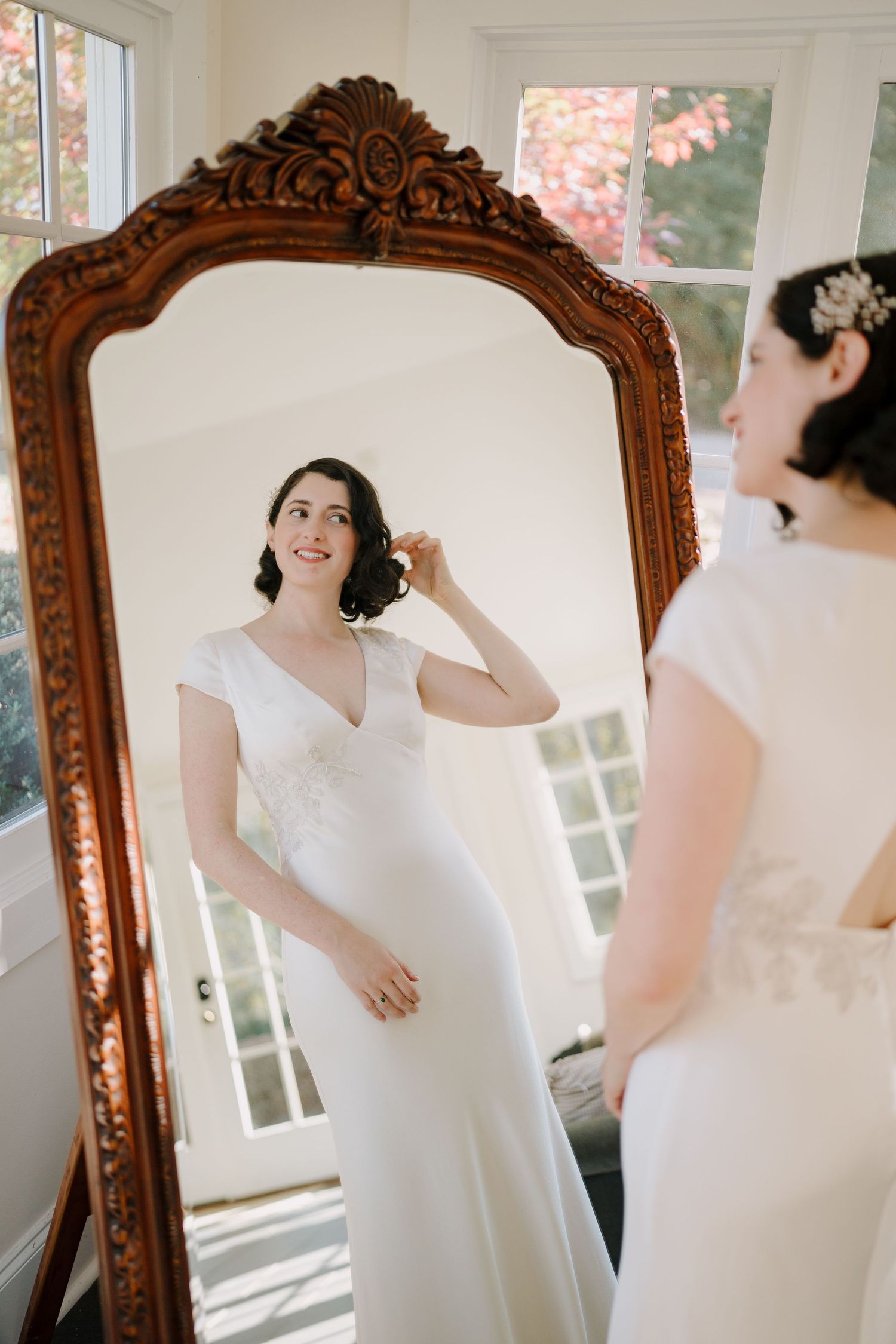 Bride looking at herself in a mirror