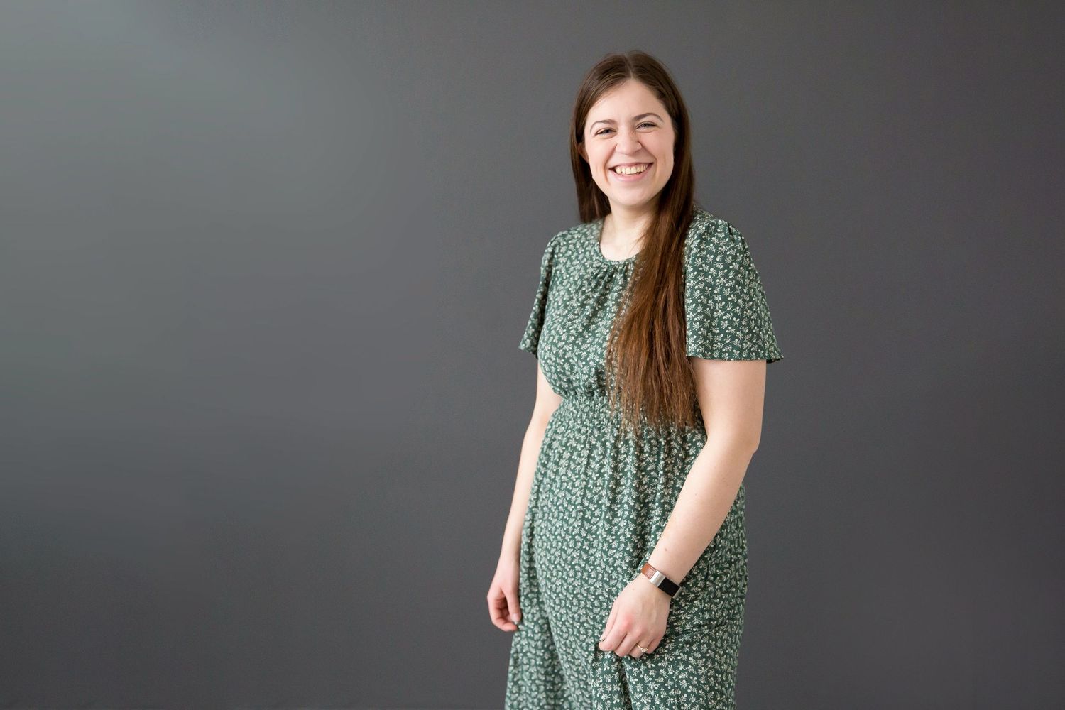 Elizabeth Mayhew Photography a lifestyle family photographer in the Peterborough region twirling a dress against a grey background