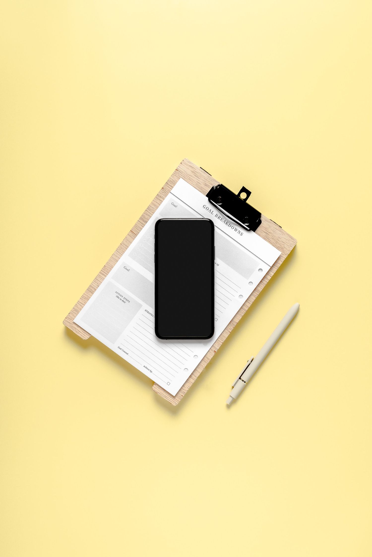 phone on top of clipboard on a yellow backdrop, minimal, fresh, online business, mock-up, stock photo