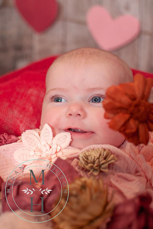 Baby girl smiling with flowers