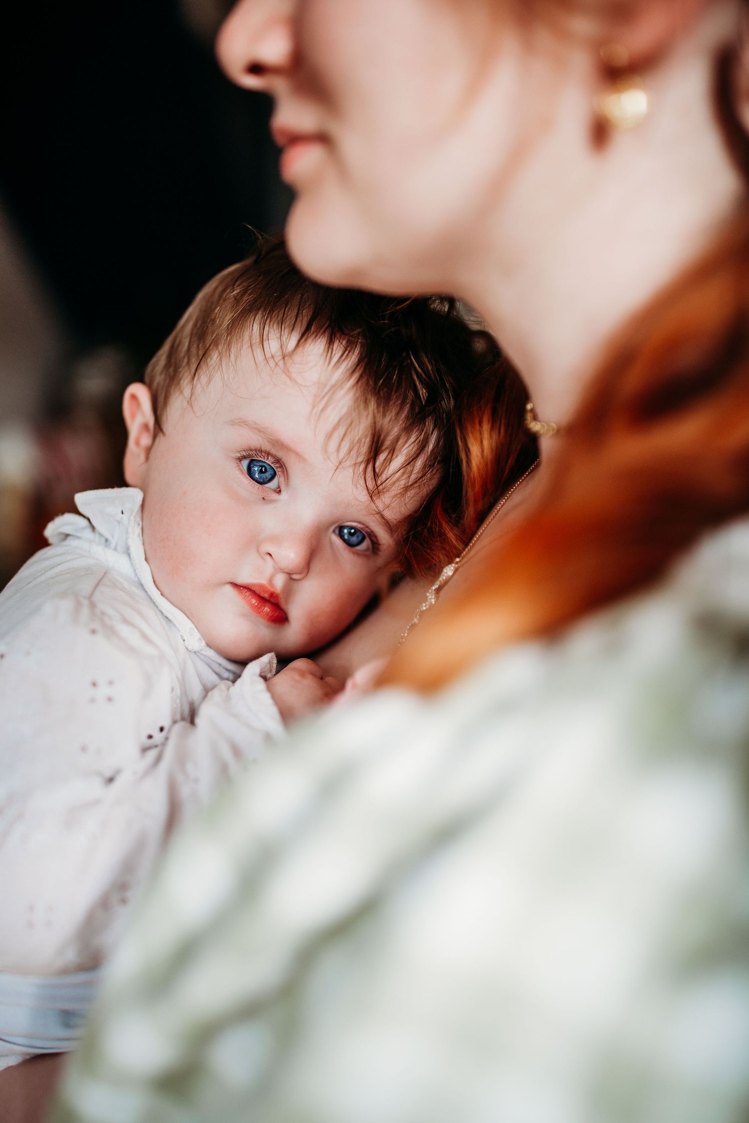 Close-up portrait capturing a tender family moment in warm lighting.
