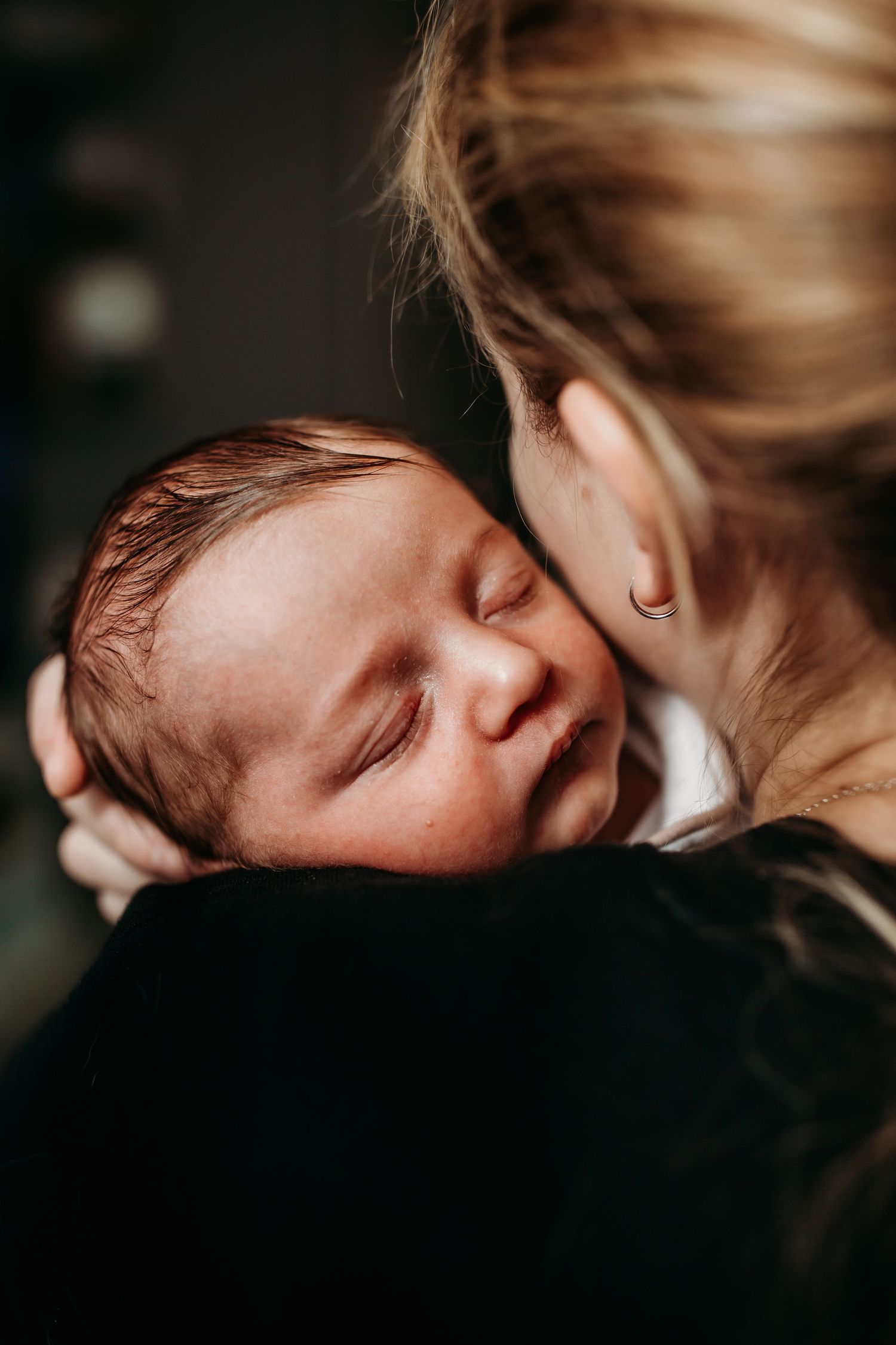 Intimate moment showing a tender embrace in soft, natural lighting.