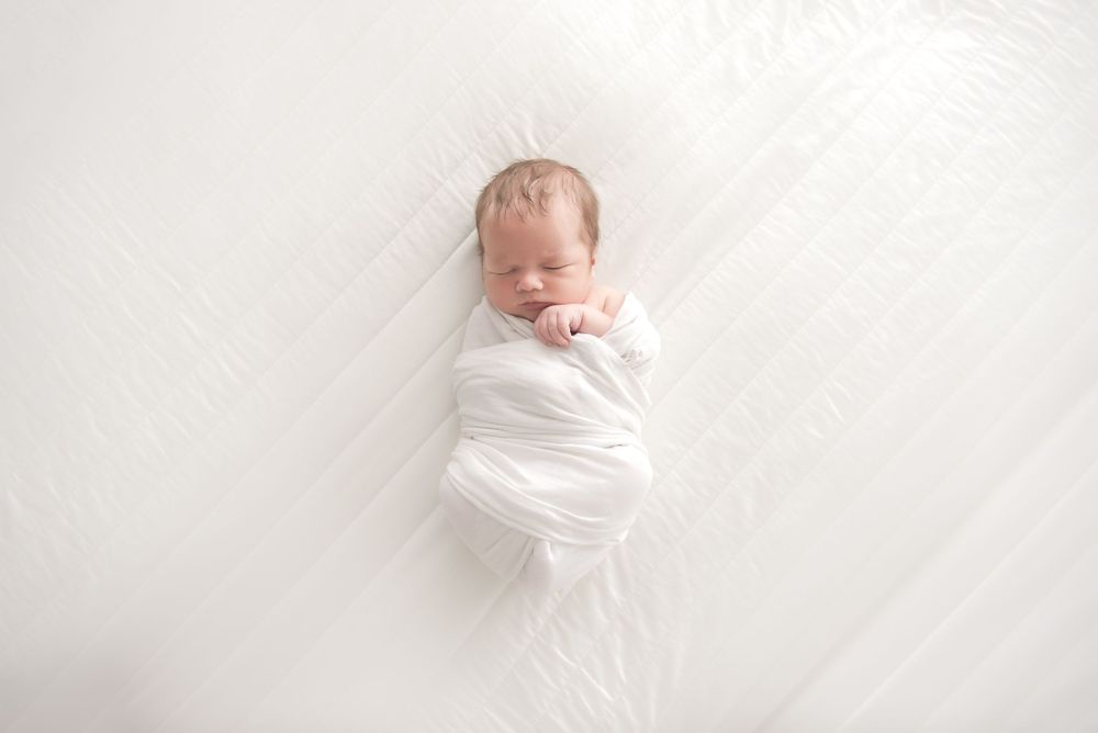 wrapped newborn in white minimalist Halifax studio photography