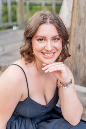 Outdoor summer portrait in a navy dress with turquoise jewelry.