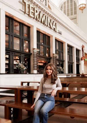 Casual portrait at Termina restaurant with rustic wooden benches.