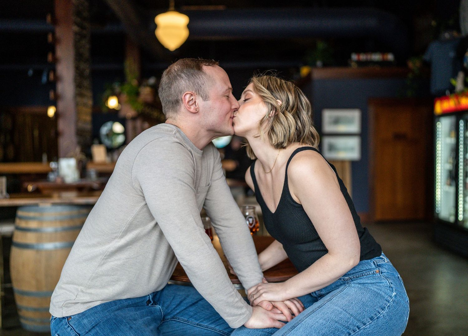 A tender moment shared between two people at a casual restaurant.