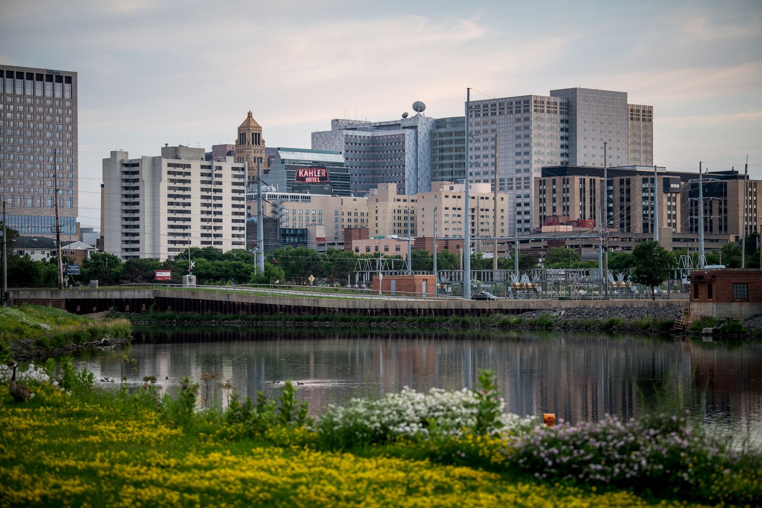 Rochester city skyline reflects in the Genesee River during sunset.