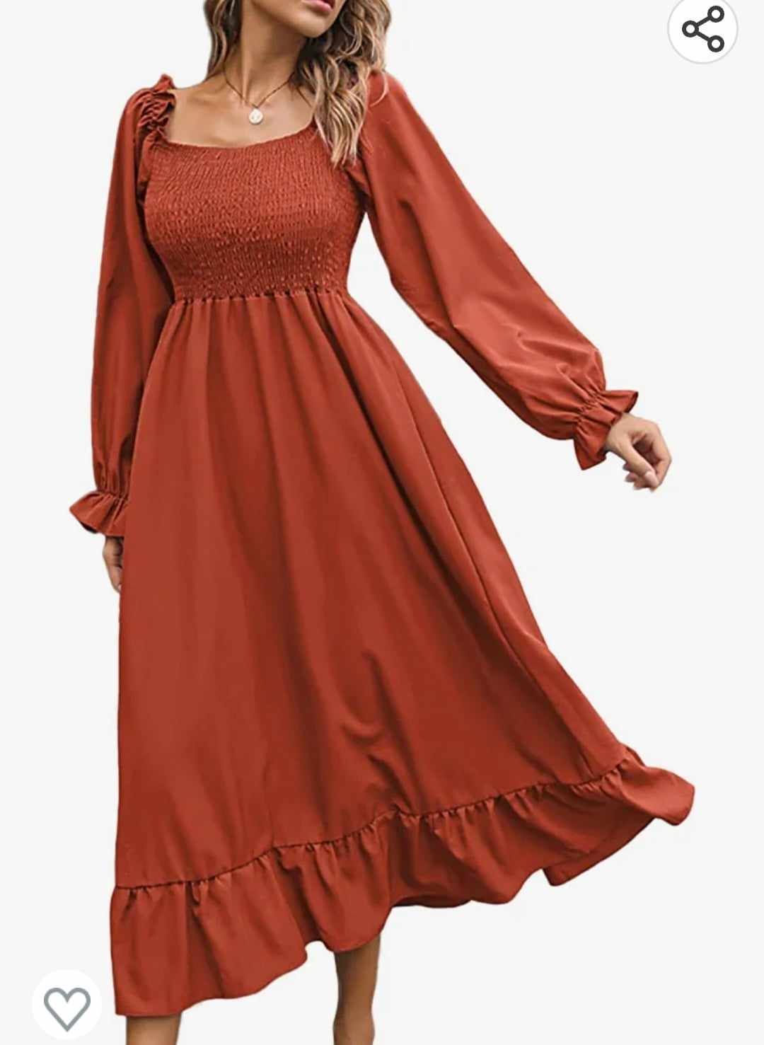 Rust-colored maxi dress with smocked bodice, long sleeves and ruffled hem displayed on white background.
