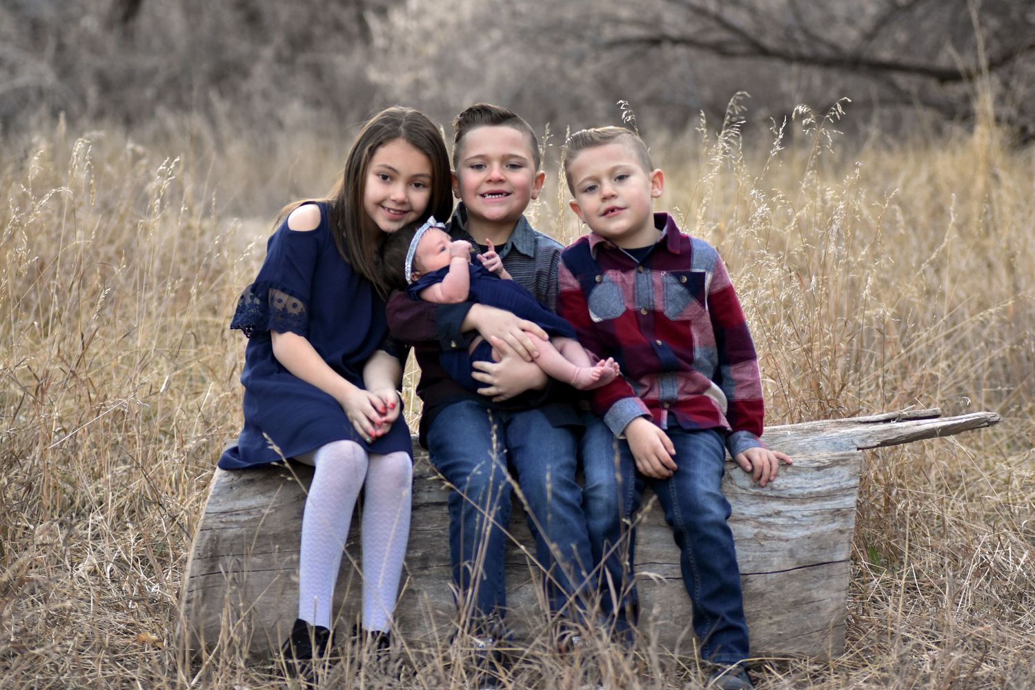 Kids sitting on a log