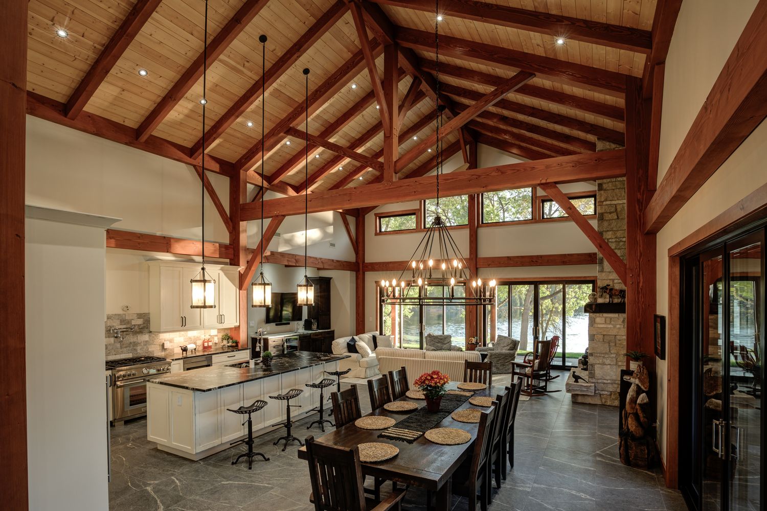 Spacious lodge interior with exposed wooden beams and vaulted ceiling.