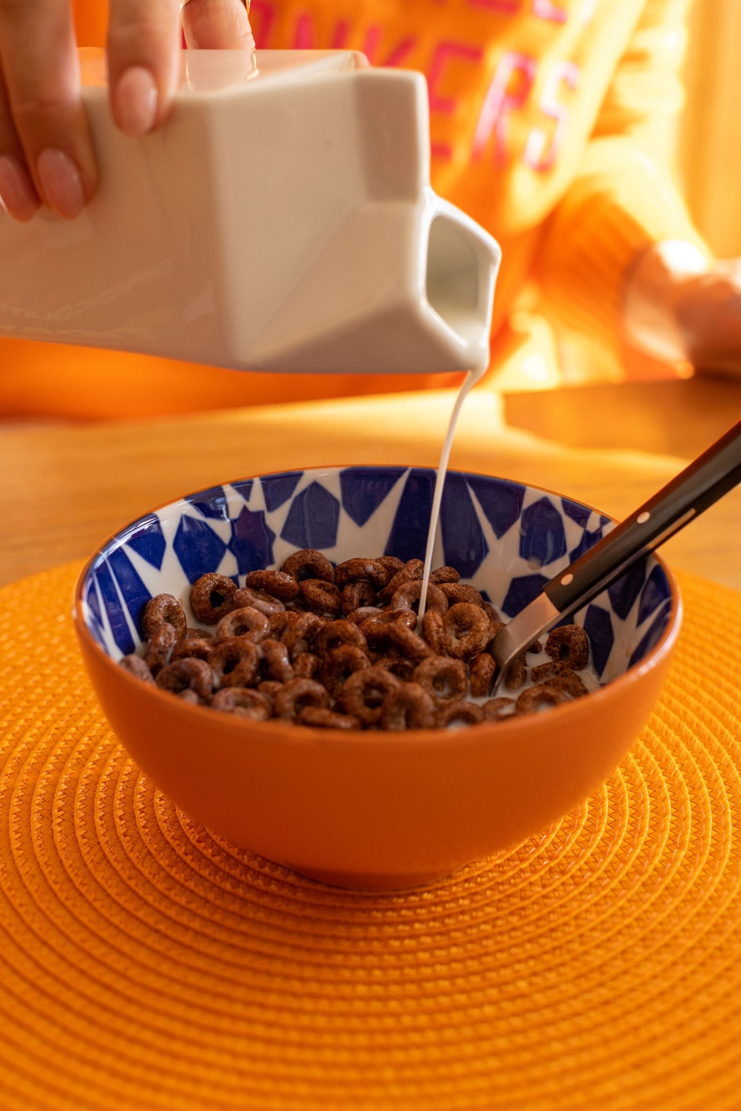 Close up of milk being poured into chocolate orange weetos cereal for an instagram ad for influencer marketing.