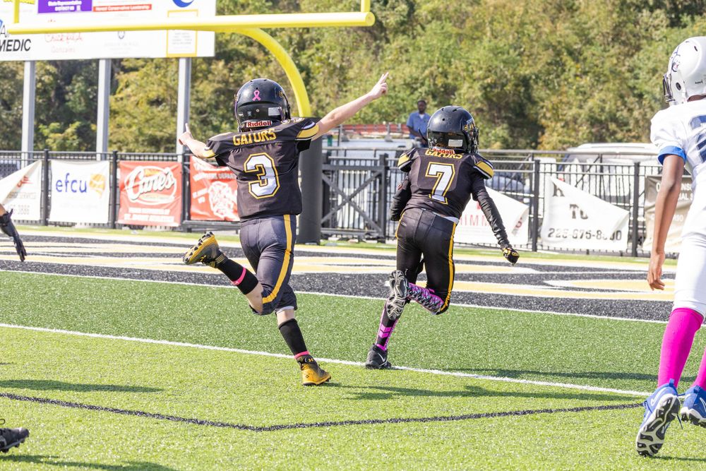 Two football players celebrating a touchdown