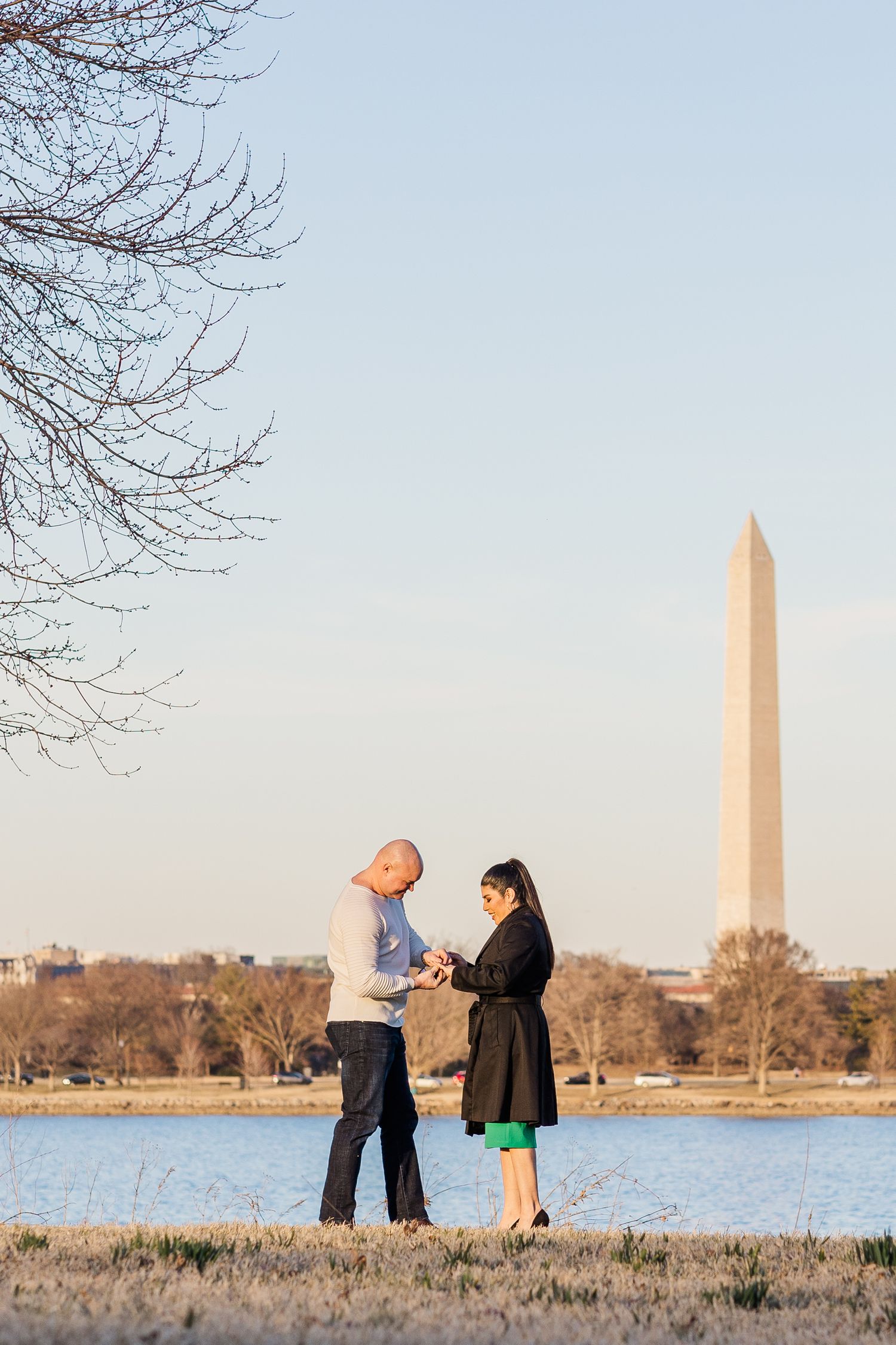 A romantic proposal moment by the Washington Monument with the Tidal Basin in view.