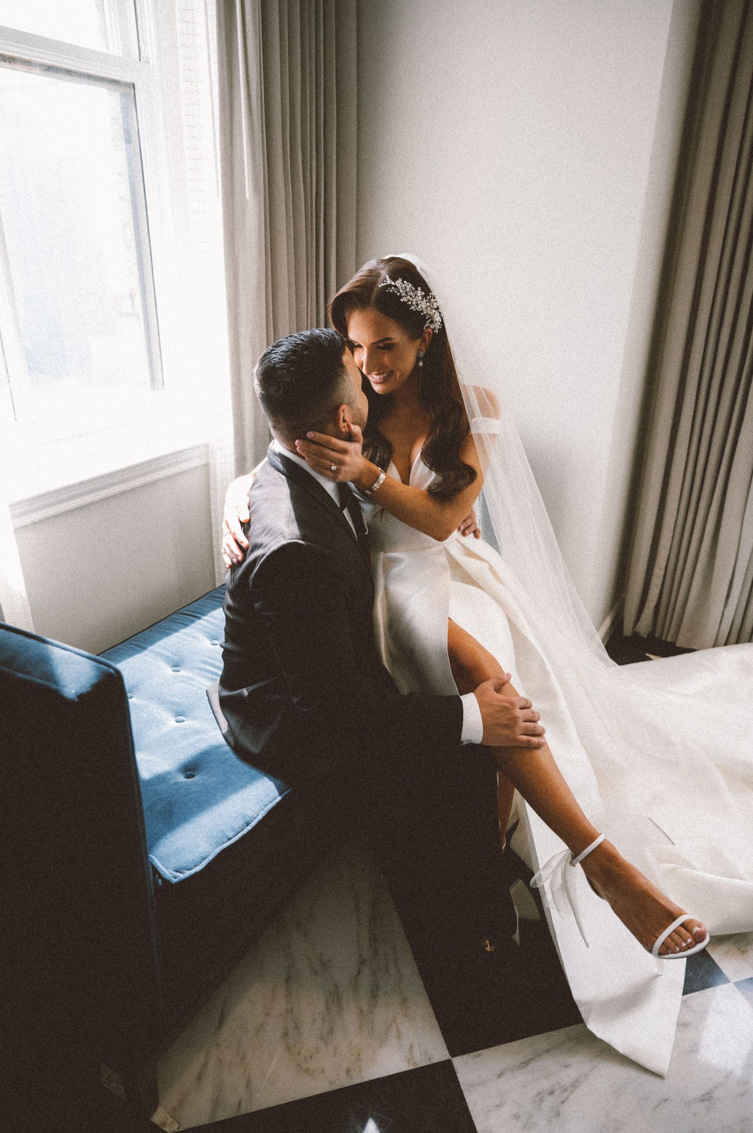 An intimate moment captured in a room with black and white checkered flooring.