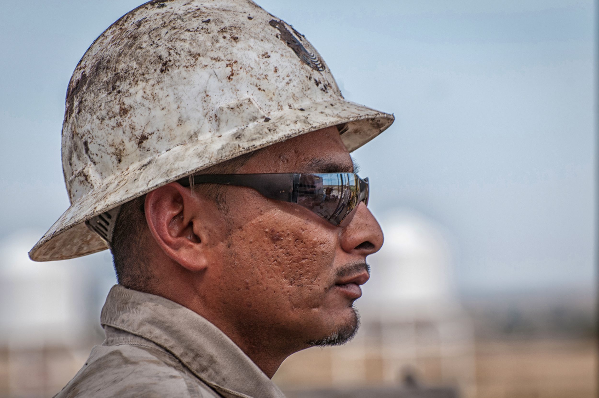 Profile view of drilling rig worker with hardhat