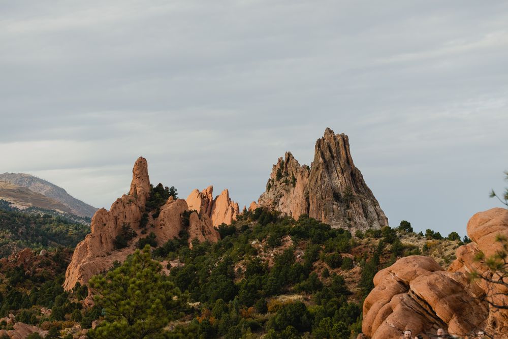 Dramatic red rock formations rise against cloudy skies at Garden of the Gods in Colorado.