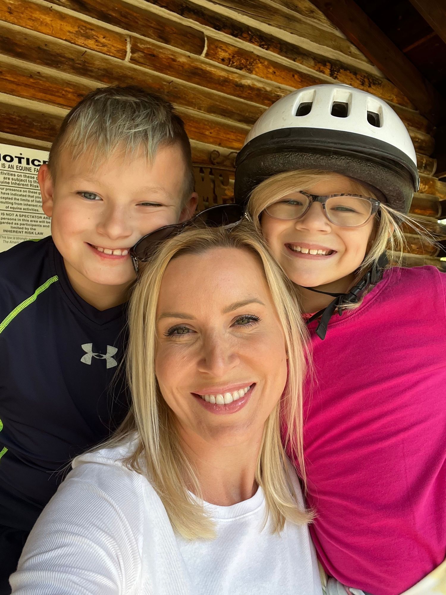 Family selfie photos taken under wooden beams in casual clothing.