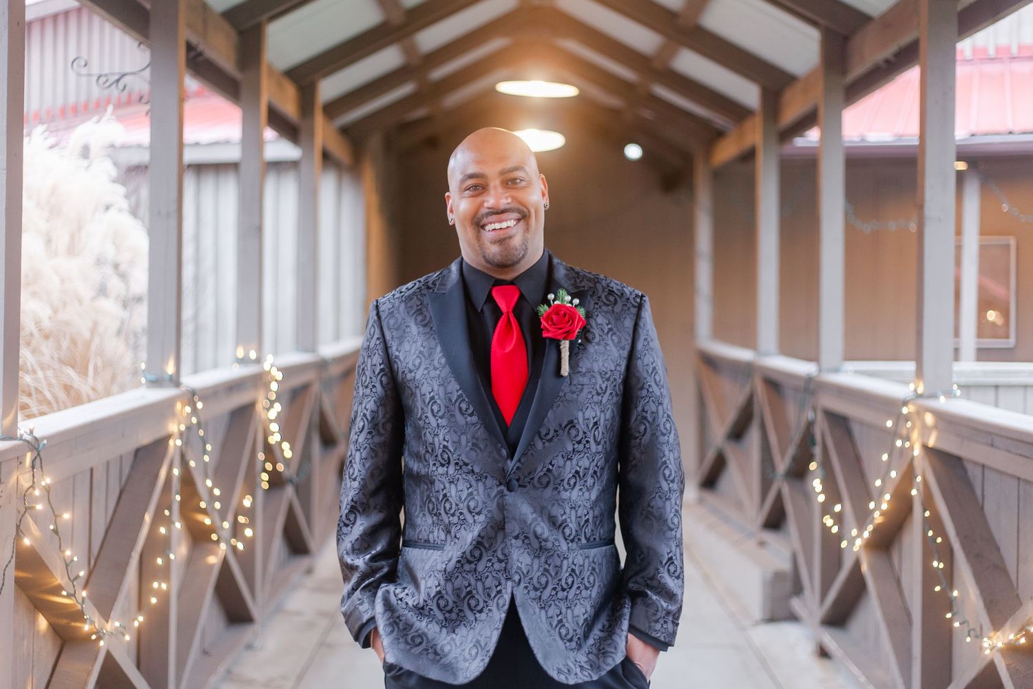 Wedding venue interior decorated with wooden beams and twinkling lights.