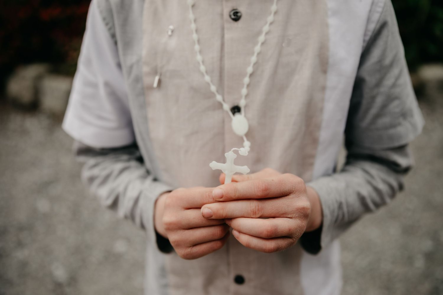 Hands holding rosary beads at communion