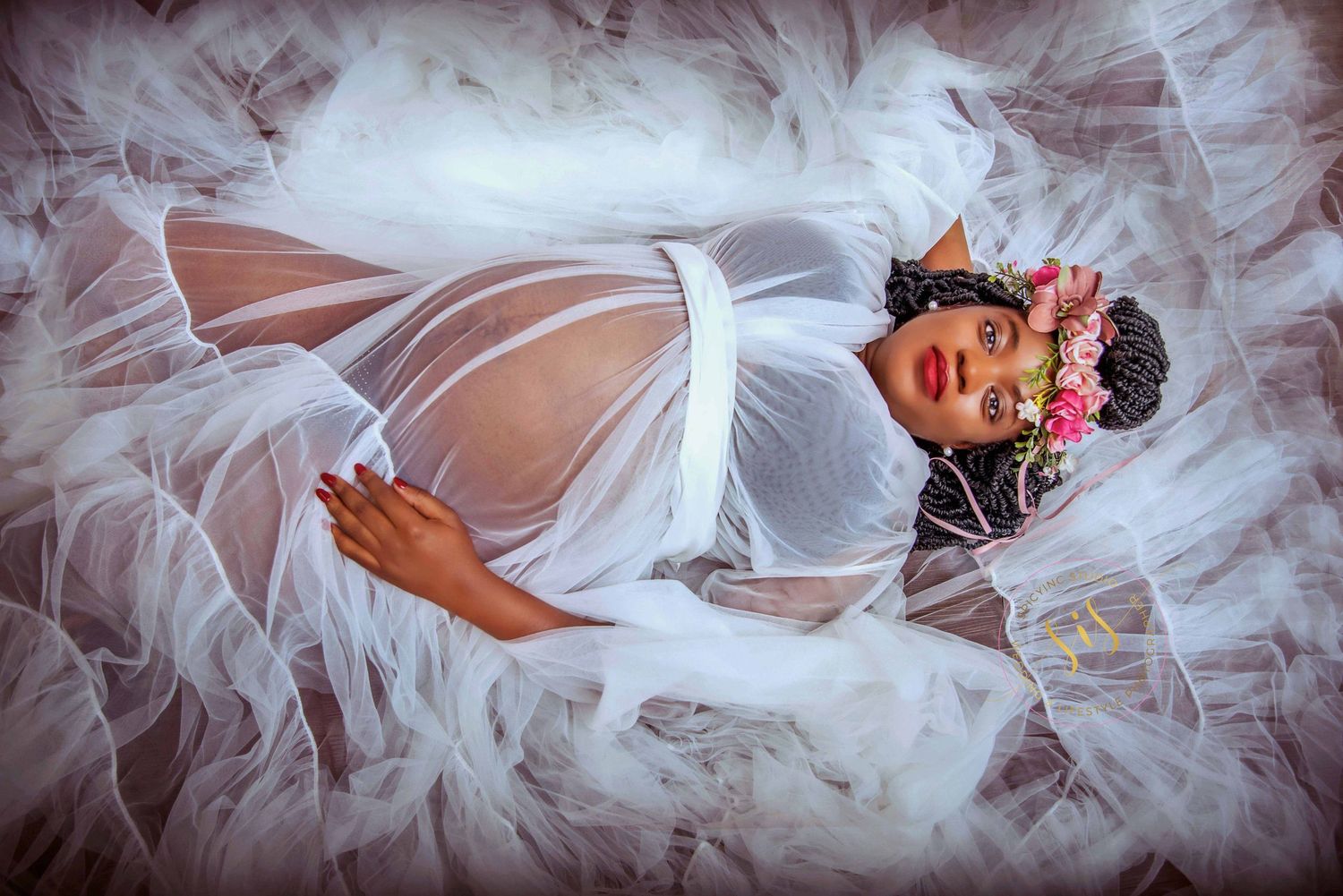 Artistic bridal photo showing flowing white tulle fabric creating ethereal effect.
