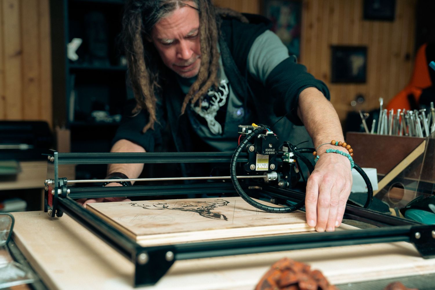 Man working on laser cutting wood