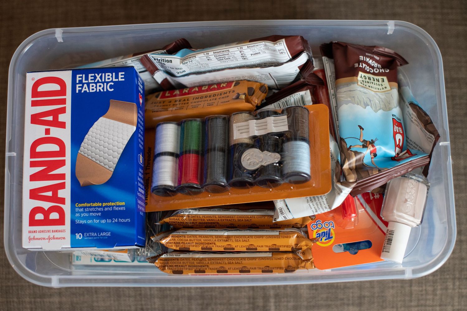 First aid and medical supplies organized neatly in clear plastic storage containers.