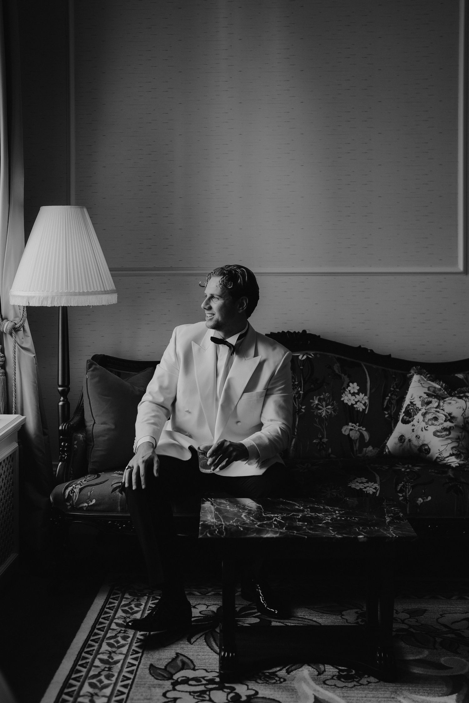 groom sat looking out window at the Randolph hotel in oxford